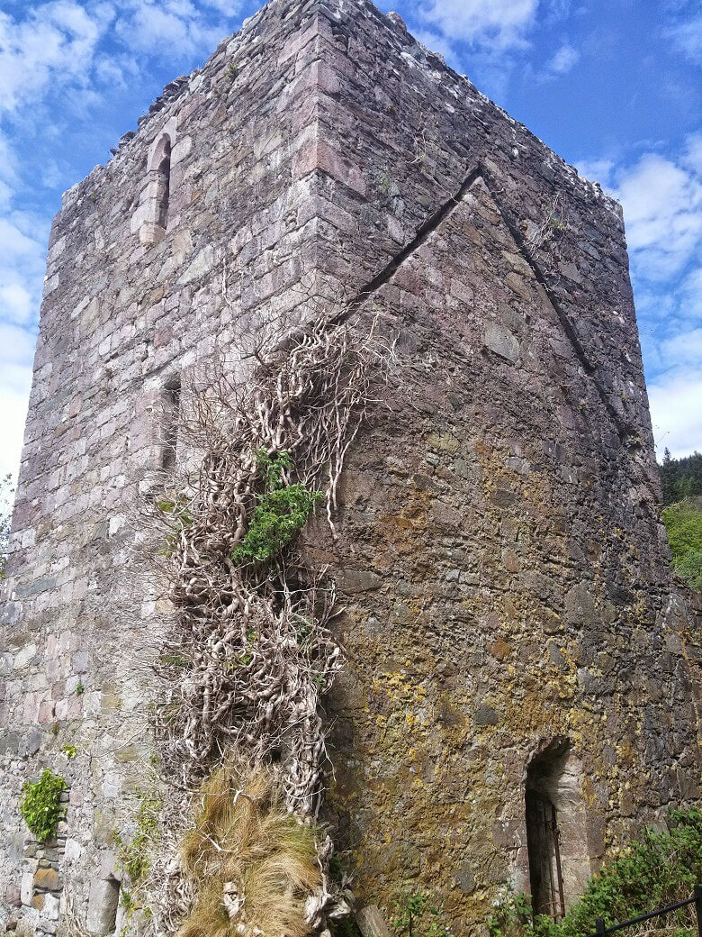 A ruined stone tower with ivy on the walls