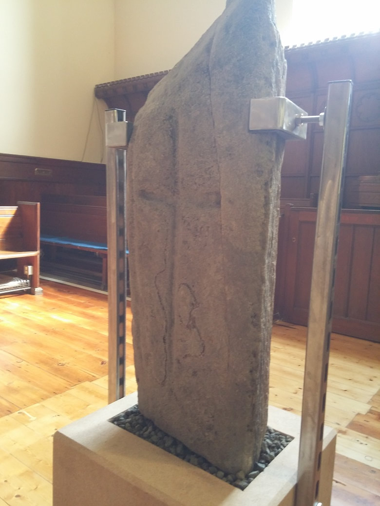 A upright stone slab with carved cross