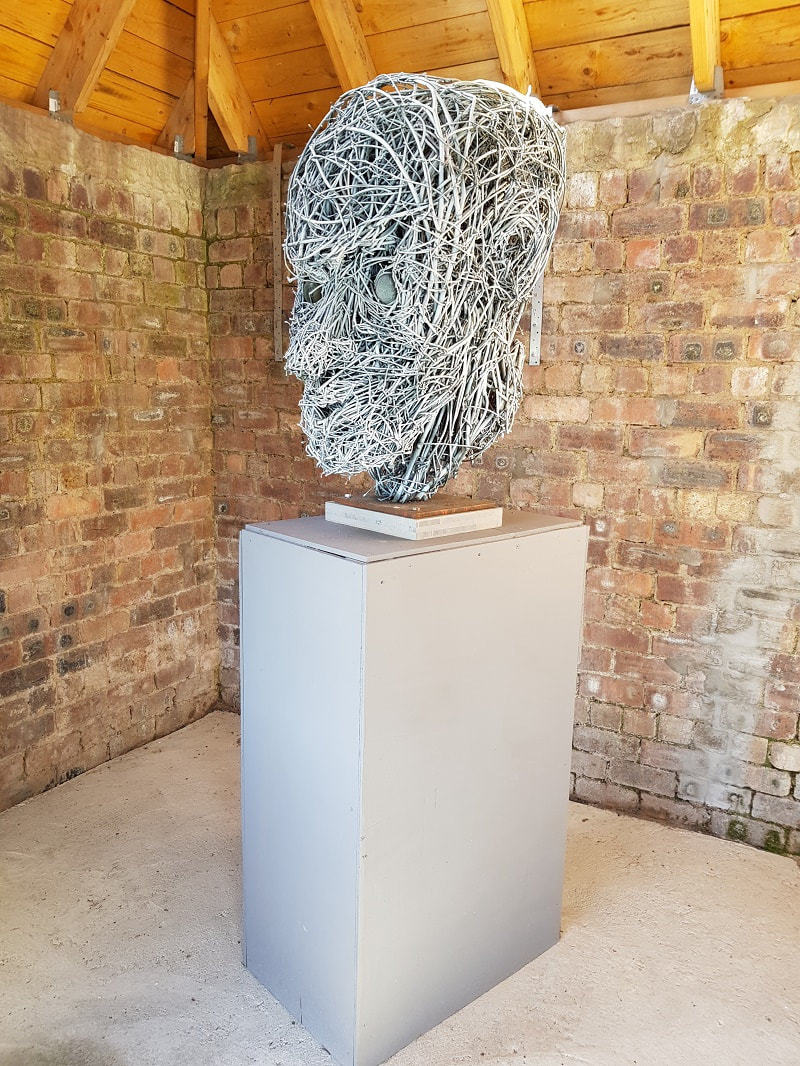 A sculpture of a  head made from metal wire