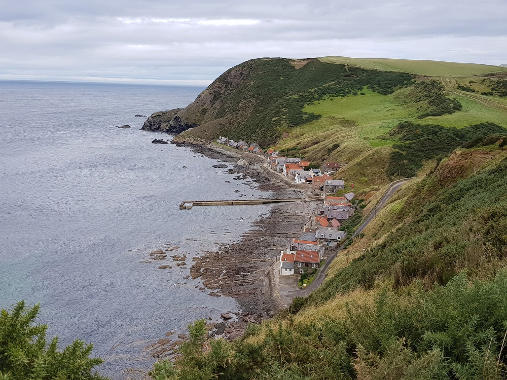 A row of cottages built between the sea and cliffs