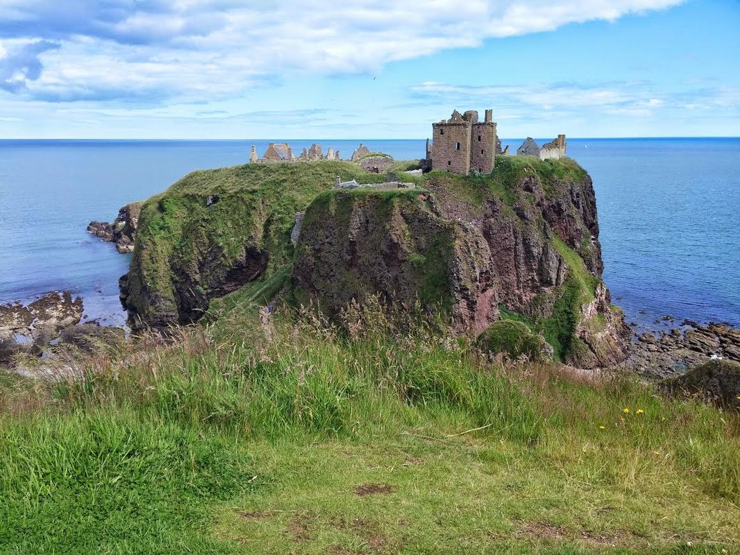 A ruined castle perched on a clifftop