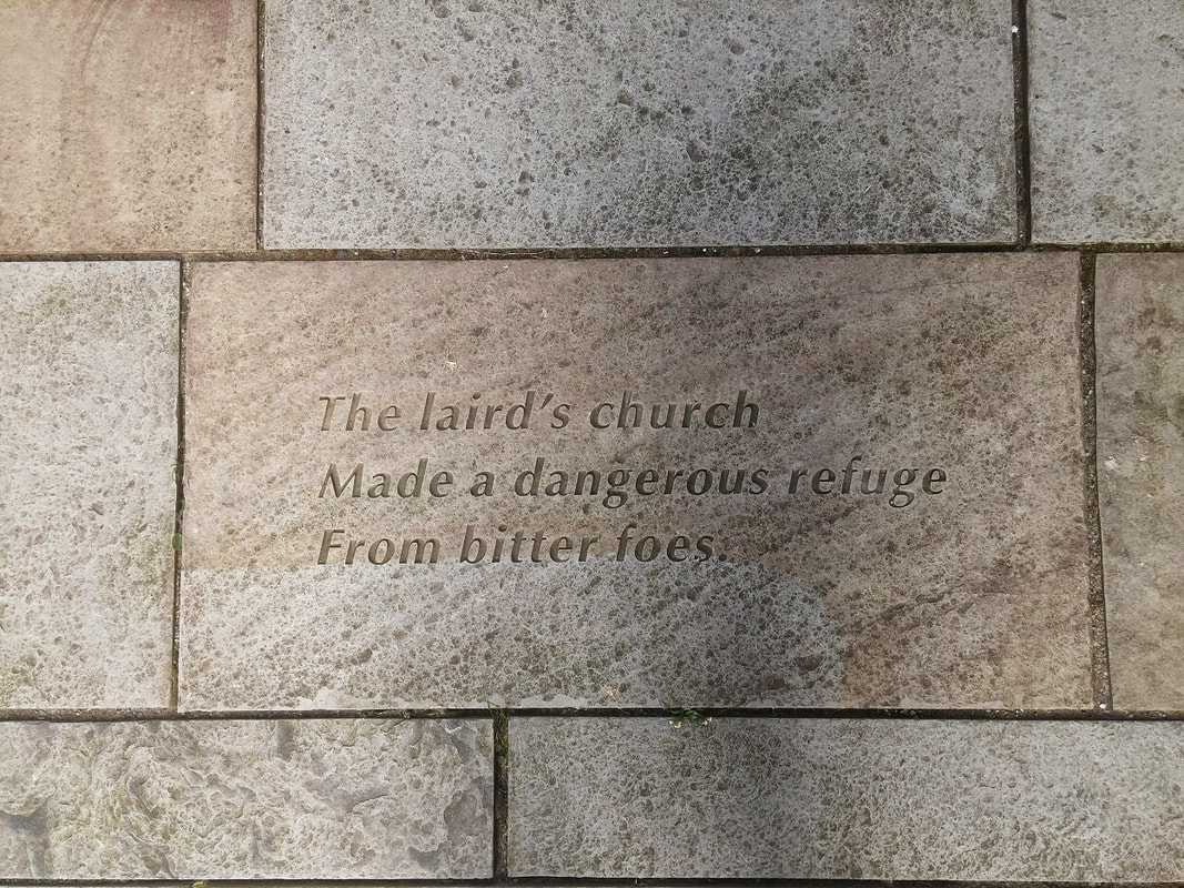 A stone floor tile with the words The laird's church made a dangerous refuge from bitter foes